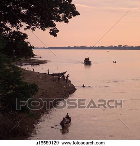 Stock Photo - Boats along shoreline of Ayevanwady River. Fotosearch