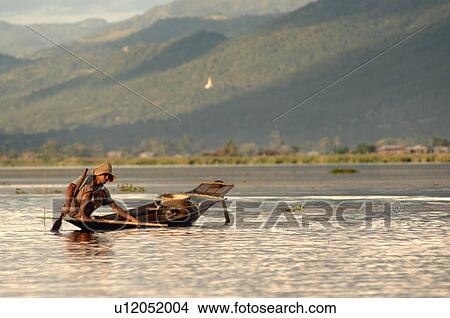 Picture - Boy fishing from boat. Fotosearch