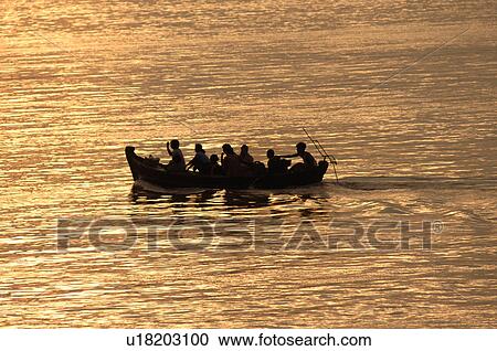 Stock Image - Canoe on the Irrawaddy River. Fotosearch
