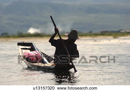 Stock Image - Crouching fisherman. Fotosearch