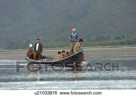 Stock Photograph - Family in motorized boat. Fotosearch