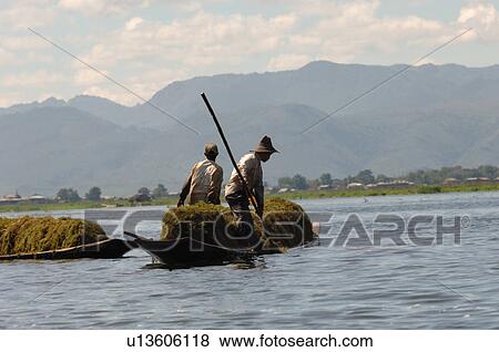 Farmers in row boat View Large Photo Image Stock Photo - Farmers in row boat. Fotosearch