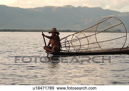 Fisherman in row boat View Large Photo Image Stock Photo - Fisherman in row boat. Fotosearch