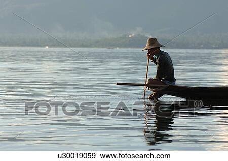Stock Photo - Fisherman in row boat. Fotosearch