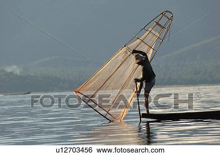 Fisherman in row boat View Large Photo Image Stock Photograph - Fisherman in row boat. Fotosearch