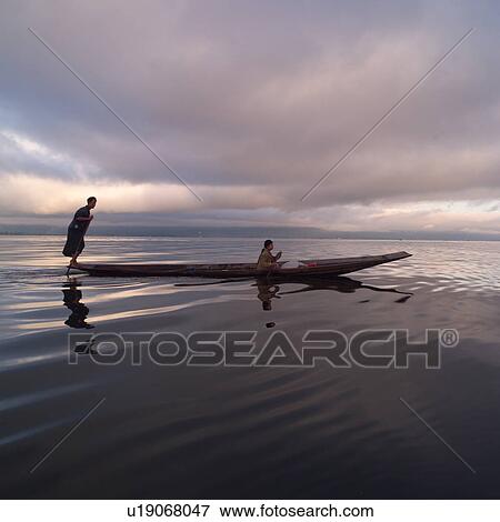 Intha fisherman in his flat-bottomed boat View Large Photo Image Stock Photo - Intha fisherman in his flat-bottomed boat. Fotosearch