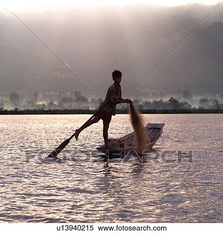 Intha fisherman in his flat-bottomed boat View Large Photo Image Stock Photography - Intha fisherman in his flat-bottomed boat. Fotosearch