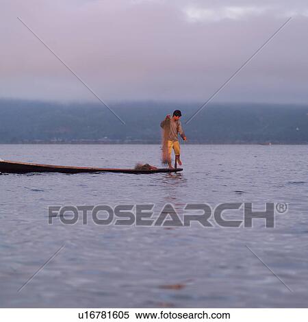 Intha fisherman in his flat-bottomed boat View Large Photo Image Stock Photography - Intha fisherman in his flat-bottomed boat. Fotosearch