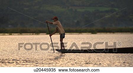 Stock Photography - Man rowing along lake. Fotosearch