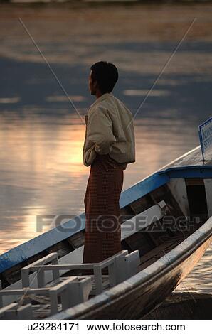 Man standing in row boat View Large Photo Image Stock Image - Man standing in row boat. Fotosearch