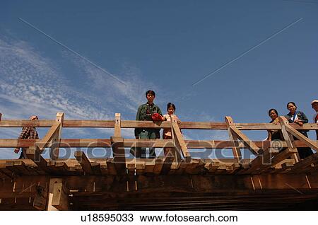 People standing on bridge View Large Photo Image Stock Image - People standing on bridge. Fotosearch