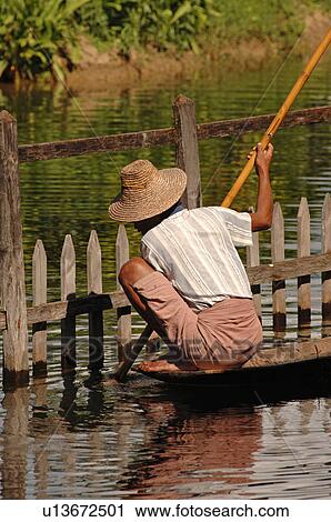 Stock Image - Woman in row boat. Fotosearch
