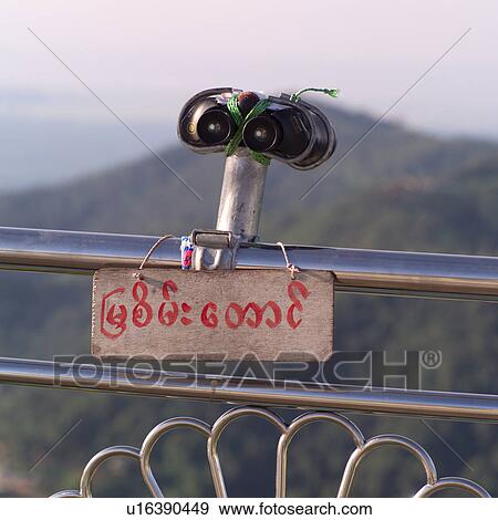 Stock Photo - Binoculars on rail at Gold Rock shrine. Fotosearch
