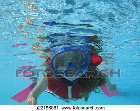 Stock Image - Underwater view of a young girl. Fotosearch
