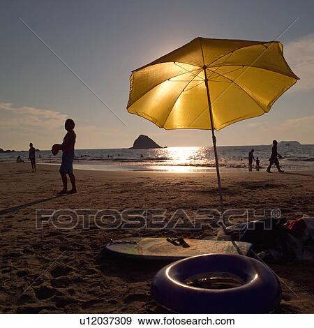Yellow Umbrella on the beach View Large Photo Image Stock Photo - Yellow Umbrella on the beach. Fotosearch