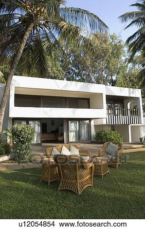 Picture - Armchair and a couch in a lawn. Fotosearch