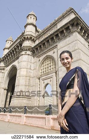 Portrait of a young woman standing in front of a monument, Gateway Of India, Mumbai, Maharashtra, India View Large Photo Image Picture - Portrait of a young woman standing in front of a monument, Gateway Of India, Mumbai, Maharashtra, India . Fotosearch