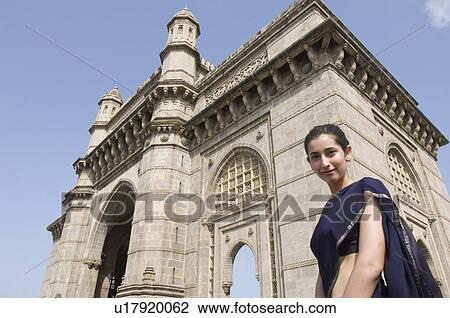 Portrait of a young woman standing in front of a monument, Gateway Of India, Mumbai, Maharashtra, India View Large Photo Image Stock Image - Portrait of a young woman standing in front of a monument, Gateway Of India, Mumbai, Maharashtra, India . Fotosearch