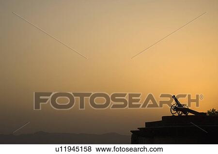 Stock Photo - Silhouette of a cannon at sunset, Neemrana Fort, Neemrana, Alwar, Rajasthan, India. Fotosearch