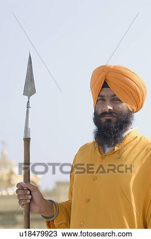 Portrait of a Sikh guard holding a spear, Golden Temple, Amritsar, India View Large Photo Image Stock Image - Portrait of a Sikh guard holding a spear, Golden Temple, Amritsar, India. Fotosearch