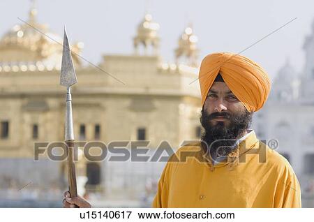 Portrait of a Sikh guard holding a spear, Golden Temple, Amritsar, Punjab, India View Large Photo Image Stock Photo - Portrait of a Sikh guard holding a spear, Golden Temple, Amritsar, Punjab, India. Fotosearch