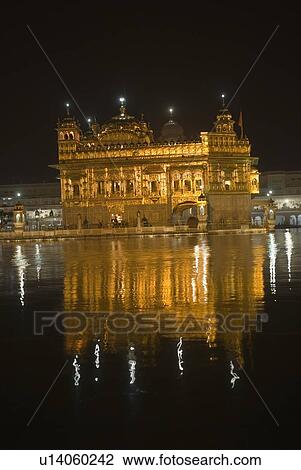 Stock Image - Reflection of a gurudwara in a pond, Golden Temple, Amritsar, Punjab, India. Fotosearch