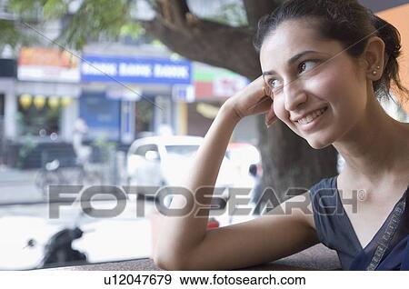 Close-up of a young woman smiling View Large Photo Image Stock Photo - Close-up of a young woman smiling. Fotosearch