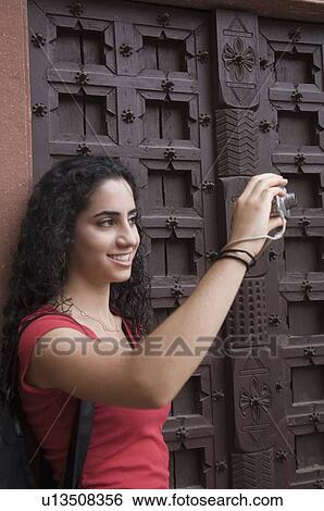 Close-up of a young woman taking a picture with a digital camera, Taj Mahal, Agra, Uttar Pradesh, India View Large Photo Image Stock Photograph - Close-up of a young woman taking a picture with a digital camera, Taj Mahal, Agra, Uttar Pradesh, India. Fotosearch