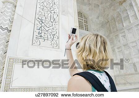 Rear view of a young woman taking a picture with a digital camera, Taj Mahal, Agra, Uttar Pradesh, India View Large Photo Image Stock Image - Rear view of a young woman taking a picture with a digital camera, Taj Mahal, Agra, Uttar Pradesh, India. Fotosearch