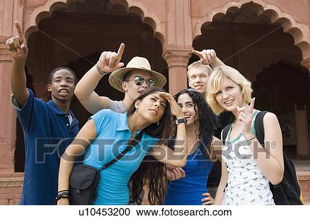 Stock Image - Close-up of a group of friends standing together, Taj Mahal, Agra, Uttar Pradesh, India. Fotosearch