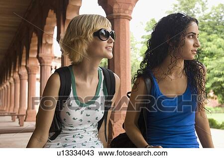 Close-up of two young women sitting together and smiling, Taj Mahal, Agra, Uttar Pradesh, India View Large Photo Image Stock Image - Close-up of two young women sitting together and smiling, Taj Mahal, Agra, Uttar Pradesh, India. Fotosearch