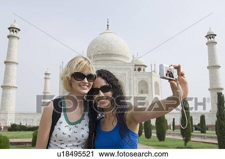 Close-up of two young women taking a picture of themselves, Taj Mahal, Agra, Uttar Pradesh, India View Large Photo Image Stock Image - Close-up of two young women taking a picture of themselves, Taj Mahal, Agra, Uttar Pradesh, India. Fotosearch