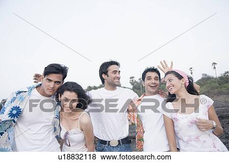 Stock Photo - Five friends hanging out on the beach. Fotosearch