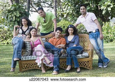 Group of friends posing in a lawn View Large Photo Image Stock Image - Group of friends posing in a lawn. Fotosearch