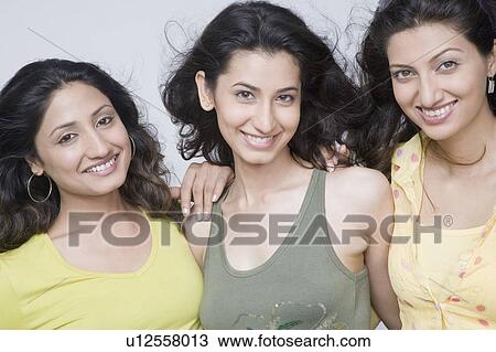 Portrait of three young woman smiling View Large Photo Image Stock Image - Portrait of three young woman smiling. Fotosearch
