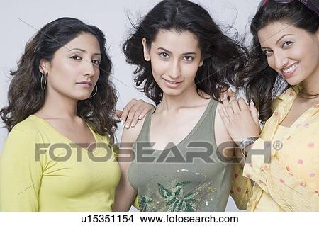 Picture - Portrait of three young women standing together and smiling. Fotosearch