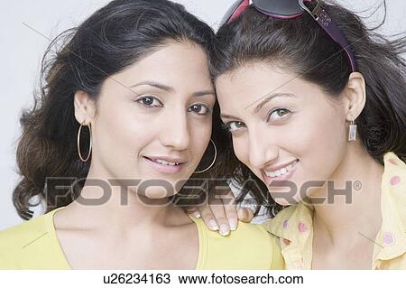 Stock Image - Portrait of two young women smiling. Fotosearch