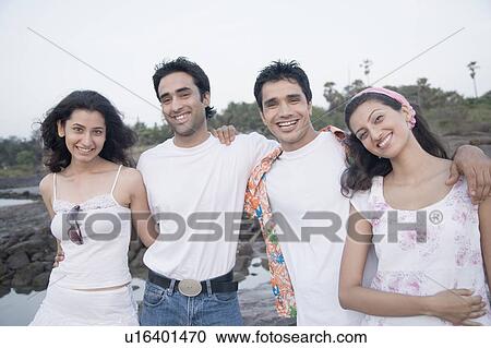 Portrait of young couple smiling together View Large Photo Image Stock Image - Portrait of young couple smiling together. Fotosearch