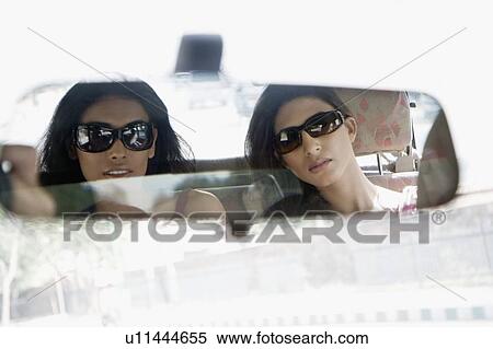 Reflection of two young women in a rear-view mirror of a car View Large Photo Image Stock Photography - Reflection of two young women in a rear-view mirror of a car. Fotosearch