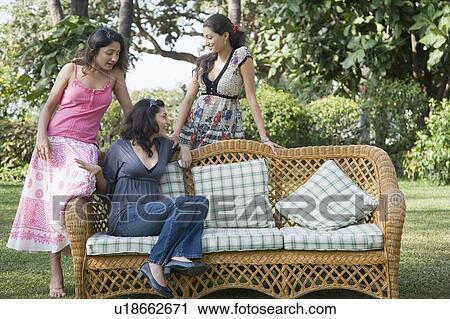 Three young women in a park and smiling View Large Photo Image Stock Image - Three young women in a park and smiling. Fotosearch