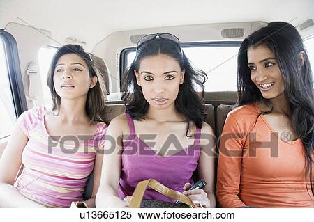 Three young women traveling in a car View Large Photo Image Stock Photography - Three young women traveling in a car. Fotosearch