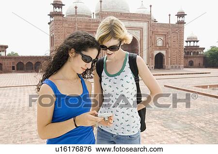 Two young women looking at a digital camera, Taj Mahal, Agra, Uttar Pradesh, India View Large Photo Image Stock Photograph - Two young women looking at a digital camera, Taj Mahal, Agra, Uttar Pradesh, India. Fotosearch