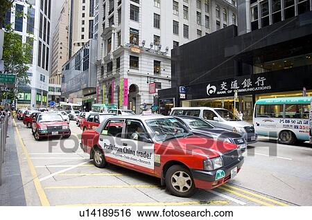 Taxies on the road in Central District, Hong Kong View Large Photo Image Stock Photograph - Taxies on the road in Central District, Hong Kong. Fotosearch