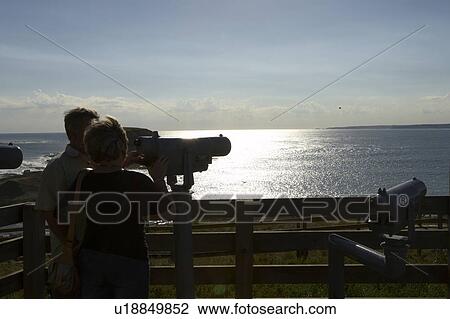 Stock Image - Couples watching view from lookout. Fotosearch