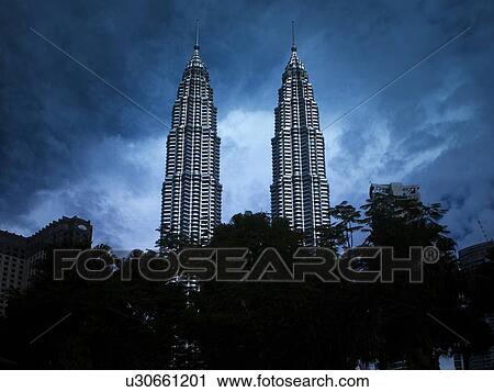 Stock Image - Storm Clouds Hanging over Petronas Towers, Kuala Lumpur. Fotosearch