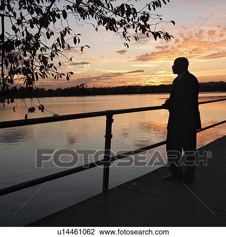 African-American man standing by water at sunset in Washington, D. C., USA. View Large Photo Image Stock Image - African-American man standing by water at sunset in Washington, D. C., USA.. Fotosearch
