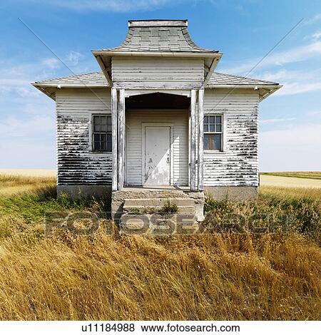 Facade of weathered abandoned building with peeling paint in grasslands. View Large Photo Image Stock Photo - Facade of weathered abandoned building with peeling paint in grasslands.. Fotosearch