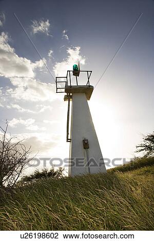 Lighthouse in grassy field View Large Photo Image Stock Image - Lighthouse in grassy field . Fotosearch