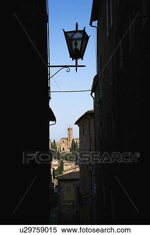 Street lamp and Siena buildings seen through darkened alley. View Large Photo Image Stock Photography - Street lamp and Siena buildings seen through darkened alley.. Fotosearch