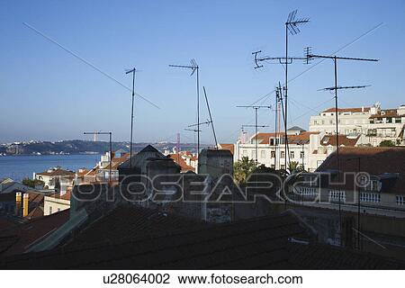 Stock Image - Urban rooftop scene with many antennas in Lisbon, Portugal.. Fotosearch